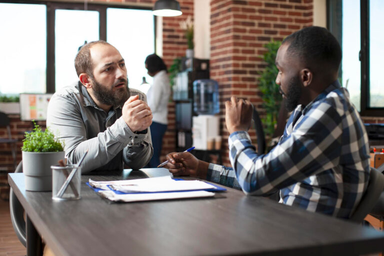 A goal setting life coach guides a client through defining personal milestones in a coaching session