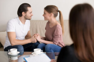 Married couple talking during a counseling session, symbolizing healing and communication through marriage counseling in Tulsa.