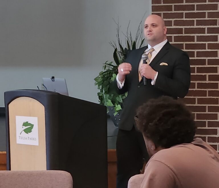 Adam Kennedy, professional life coach in Tulsa, speaks at a local event focused on practical coaching strategies